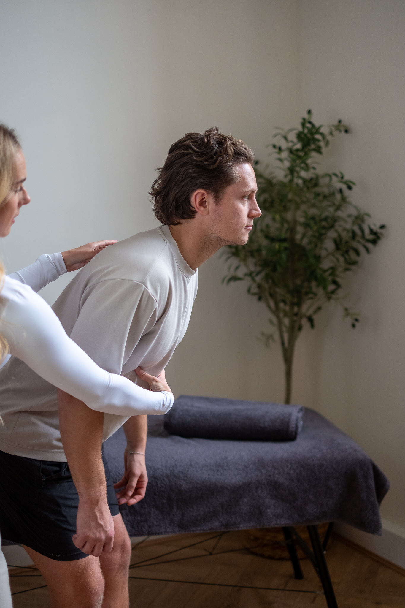 Physiotherapist performing postural assessment